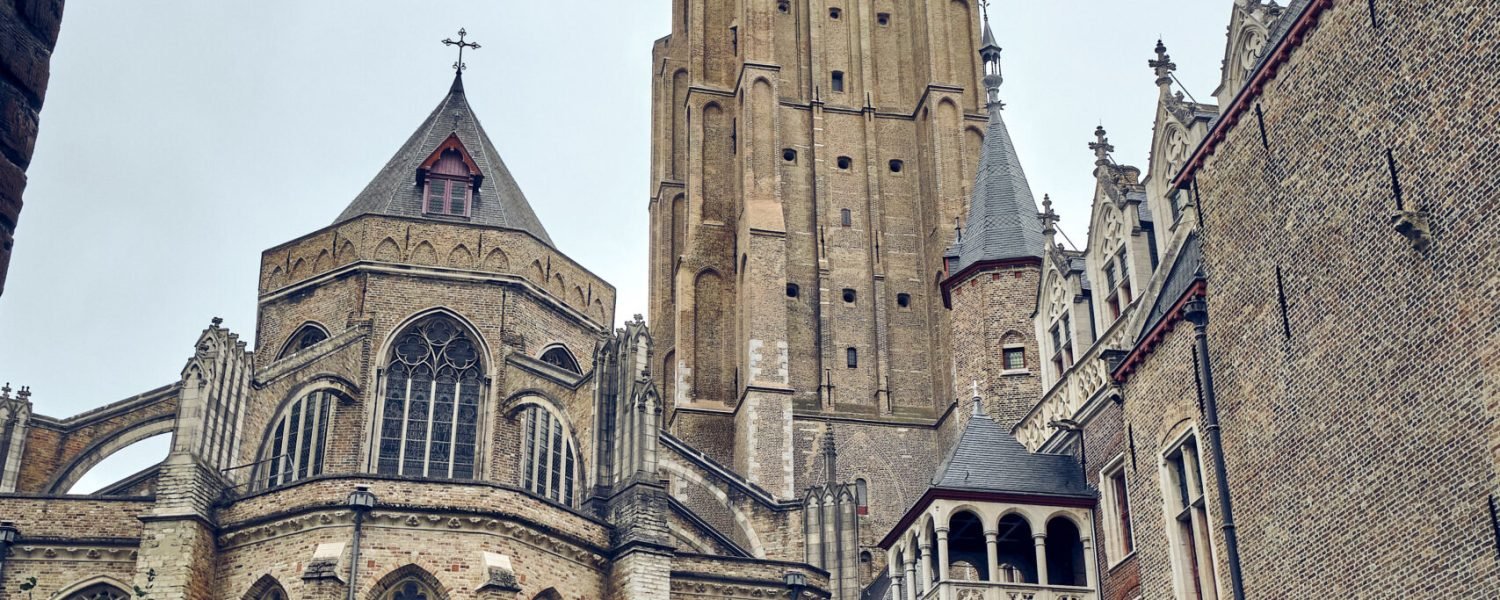 A vertical shot of the Church of Our Lady Bruges in Belgium on a clear sky background